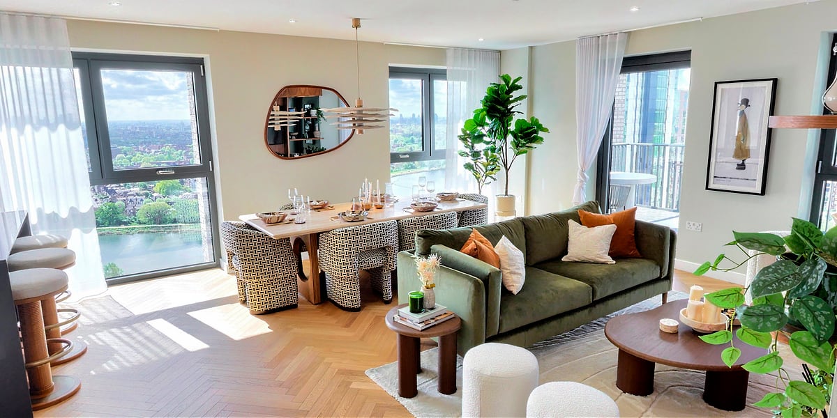 Dining table set for six, with sofa and reservoir view beyond