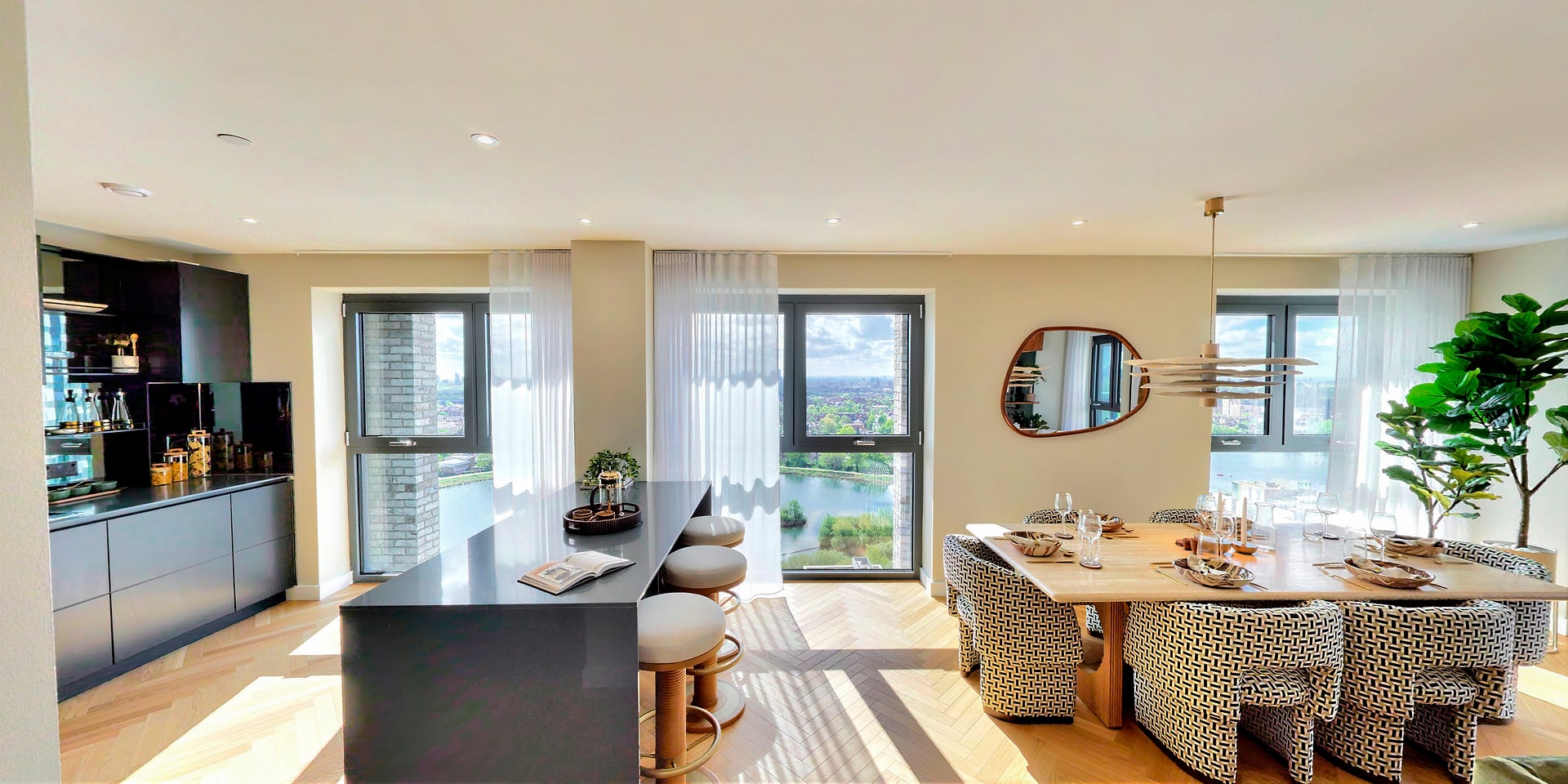 Open-plan living, dining and kitchen with wide picture windows onto the reservoir